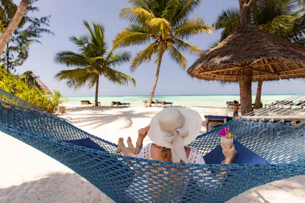 Traveler relaxing in front of hotel's beach during 4-day Zanzibar tour package vacation