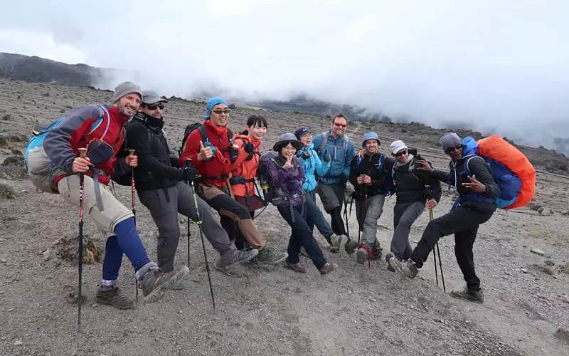 Crew celebreating during the 6-day Kilimanjaro climbing tour via the Marangu route